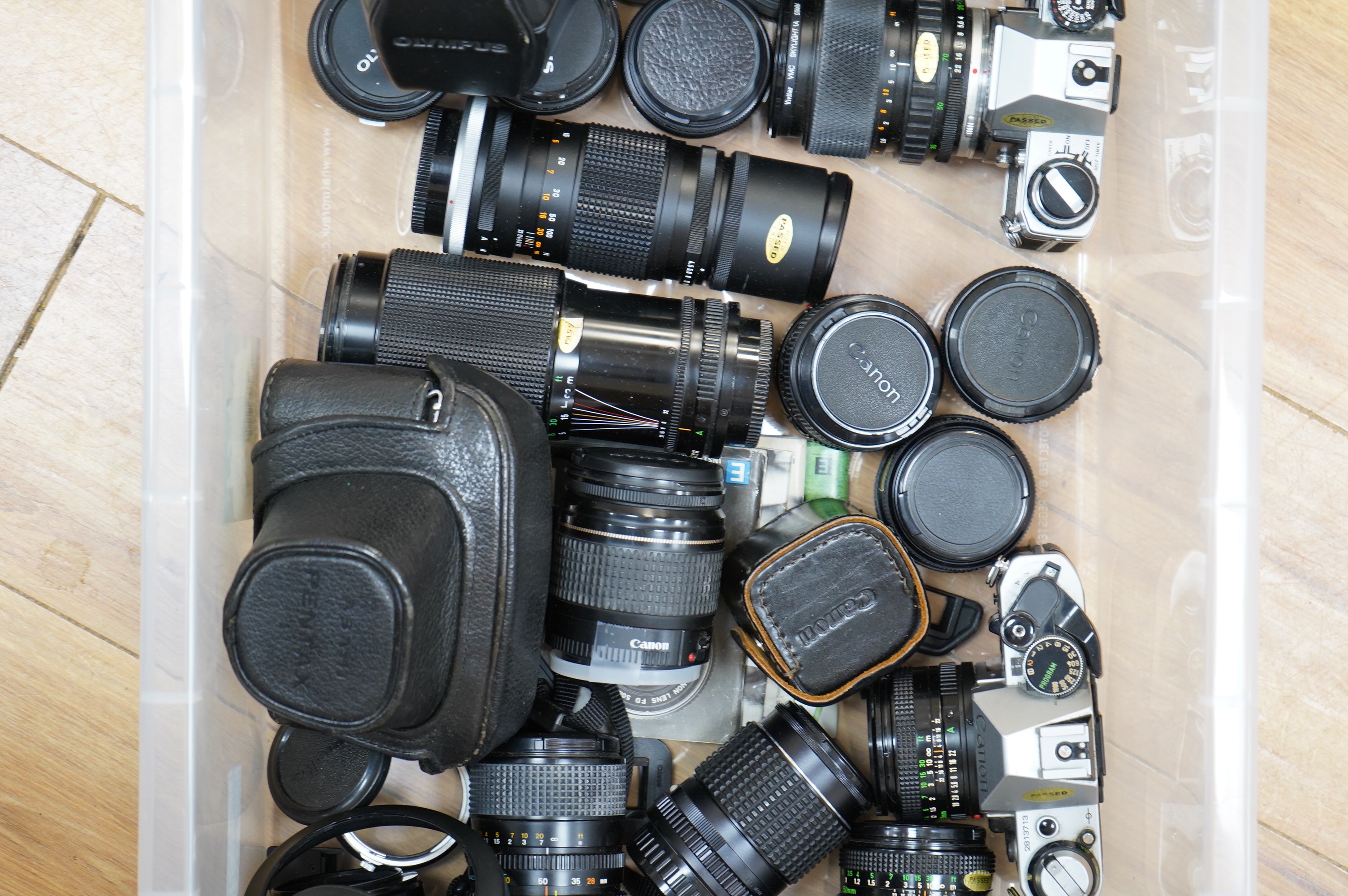 A quantity of various cameras and lenses to include Olympus, Minolta, Pentax and Canon. Condition - varies